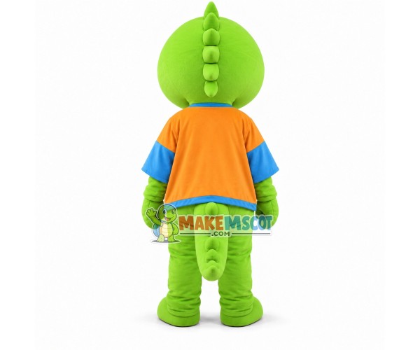 Cartoon Green Dinosaur In Orange Coat Mascot Costume Cartoon Green Dinosaur In Orange Coat Mascot Costume